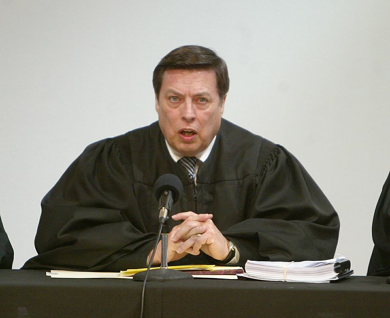 Arkansas Supreme Court Chief Justice Jim Hannah speaks to the court prior to hearing oral arguments on a case involving the city of Hot Springs' wastewater fees Thursday, April 30, 2009, at the Roy Rowe Auditorium.