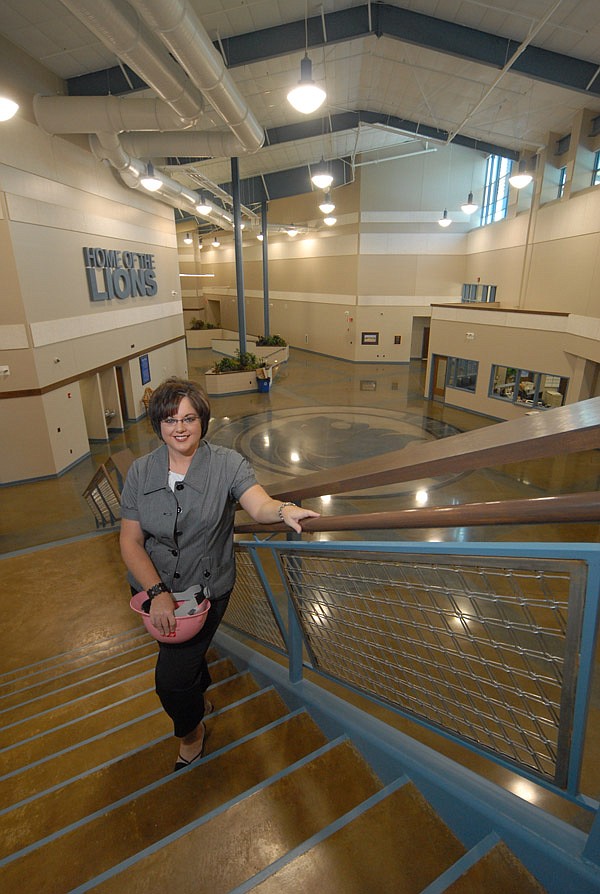 Susan Stewart, superintendent of the Bismarck School District, stands on the stairs in the new "green" high school building.