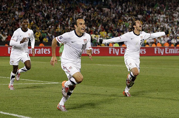 United States' Landon Donovan, center, celebrates after scoring a goal with fellow team members Benny Feilhaber, right, and Edson Buddle, left, during the World Cup group C soccer match between the United States and Algeria at the Loftus Versfeld Stadium in Pretoria, South Africa, Wednesday