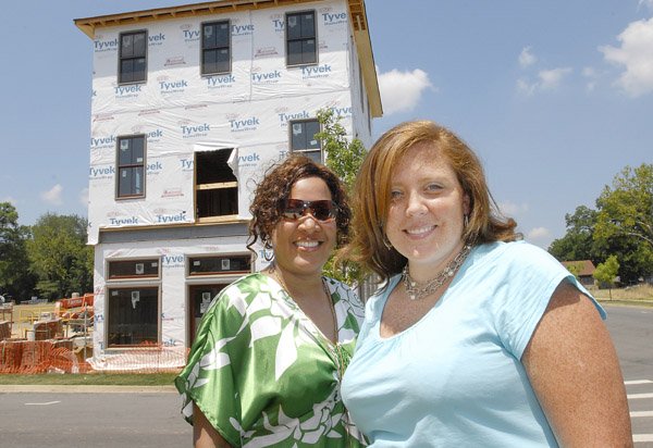 Dalencia Hervey, left, and Helen Lockhart, a designer, stand in front of Hervey’s new live/work townhouse, the first sold in The Village at Hendrix in Conway. Hervey will open a shoe store in the bottom portion, and she and her family will live in the top two stories. The unit will first be used as the Conway Symphony Designer House in September. Lockhart will serve as a liaison between the designers and the homeowners.