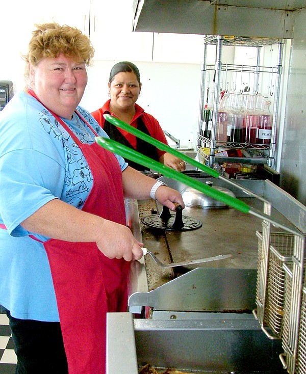 Brenda Ramsey and Alma Gurrerro in the kitchen trailer at the grill of Brenda’s Kitchen, a new restaurant on the northwest corner of Slack and Weston streets.