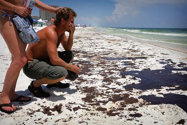 Kevin Reed of Pensacola, Fla., weeps Wednesday as he looks over the oily shores of Pensacola Beach. “This will never be the same,” Reed said.