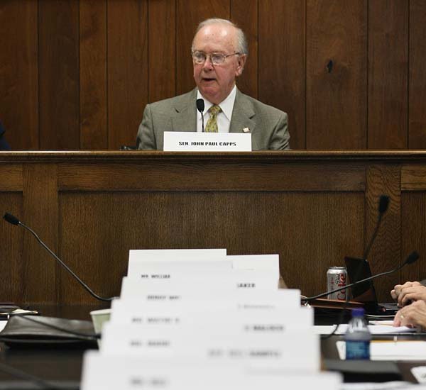   Sen. John Paul Capps, D-Searcy, presides over the first meeting of the Blue Ribbon Committee on Highway Finance at the state Capitol Thursday. The name cards for each of the other 18 committee members designate the seating arraingments.