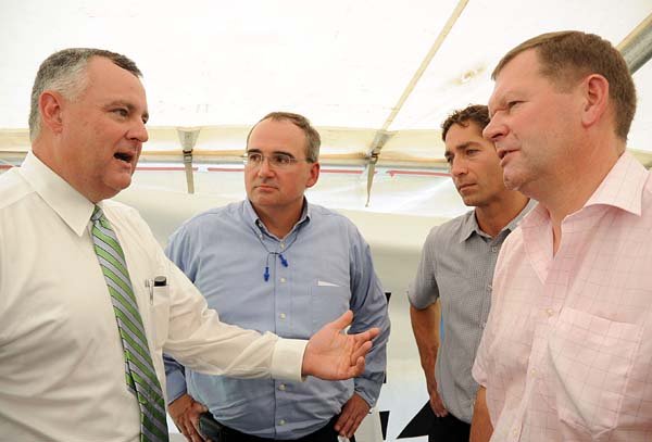 Dave Byerly (from left), the Greater Hot Springs Chamber of Commerce president and chief executive, talks with Rexam officials Terry Burcham, Steve Wirrig and Malcolm Harrison.