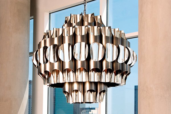 Inspired by 1960s industrial style, the Pipe chandelier from Global Views is crafted from stainless steel with an antique bronze finish on the exterior and polished nickel inside. At 36 inches in diameter, the piece is 301⁄2 inches tall and sells for $4,399.