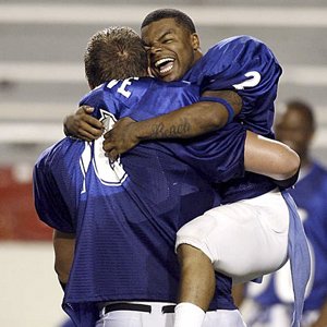 North Little Rock’s Tim Johnson leaps into the arms of East All-Stars teammate Tyler Greve of Jonesboro after Johnson was named the game’s MVP. Johnson scored four times, twice on kickoff returns of 100 and 95 yards, in the East’s 45-21 victory.

