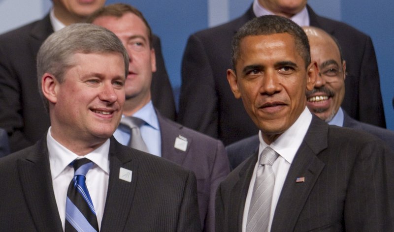 U.S. President Barack Obama, right, and Stephen Harper, Canada's president, pose during the Group of 20 family photo in Toronto, Ontario, Canada, on Sunday, June 27, 2010. G20 leaders are poised to endorse targets to tackle deficits, while giving nations flexibility to carry out their stimulus plans, according to excerpts of a draft of the statement sent to reporters.