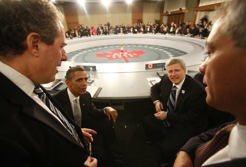 President Barack Obama and Canadian Prime Minister Stephen Harper (right) talk with White House Chief of Staff Rahm Emanuel (not pictured) and Michael Froman (left), deputy national security adviser, during the G20 Summit in Toronto on Sunday.