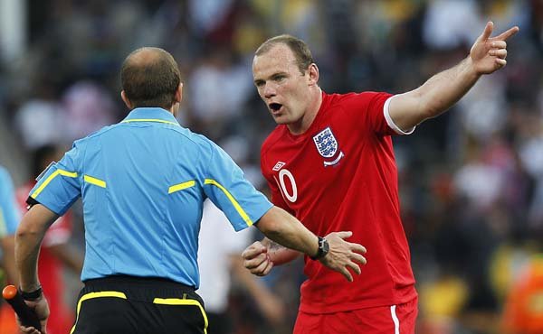 England’s Wayne Rooney (right) questions referee Pablo Fandino of Uruguay over teammate Frank Lampard’s ball that crossed the goal line but was not awarded during Sunday’s World Cup match against Germany.