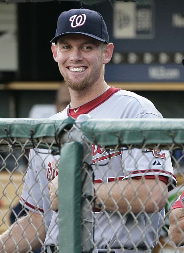  Washington Nationals pitcher Stephen Strasburg smiles while watching his team take on the Detroit Tigers in the first inning of an interleague baseball game Wednesday.