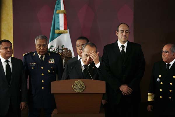 Mexico's President Felipe Calderon (center) says he blames drug cartels for the assassination of a front-running gubernatorial candidate in a statement Monday to the media in Mexico City.
