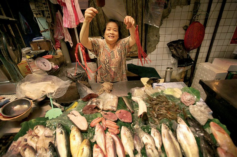 A fish monger opens her shop Tuesday in Taipei, Taiwan. China and Taiwan signed a trade pact Tuesday that strengthens economic ties between the rivals.