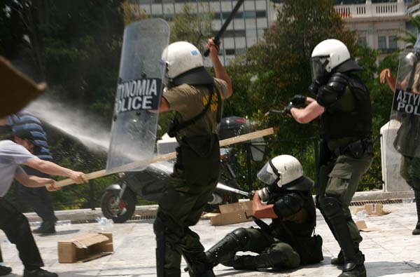 Strikers clash with riot police Tuesday during a demonstration in central Athens.