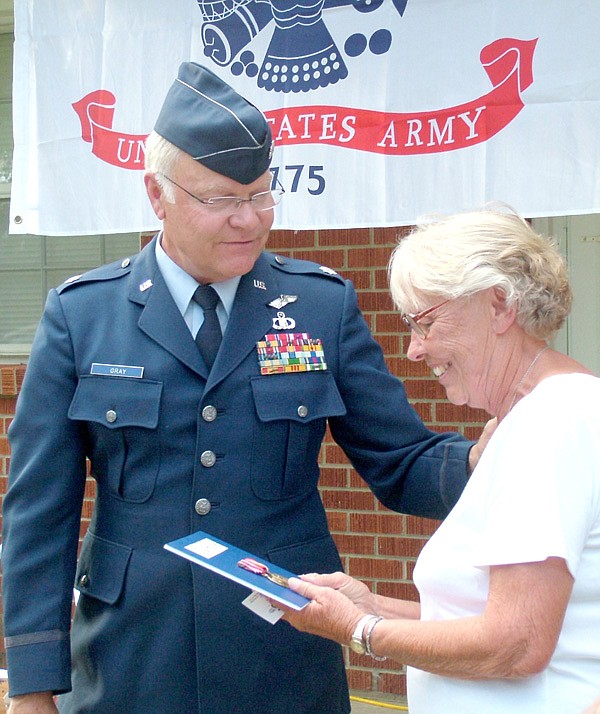 Steve Gray, military and veterans advisor to Congressman John Boozman, presented two medals to Beverly Hillyer, widow of Jackie Hillyer, who served in the U.S. Army in the mid-1950s. Family gathered Monday evening to celebrate.