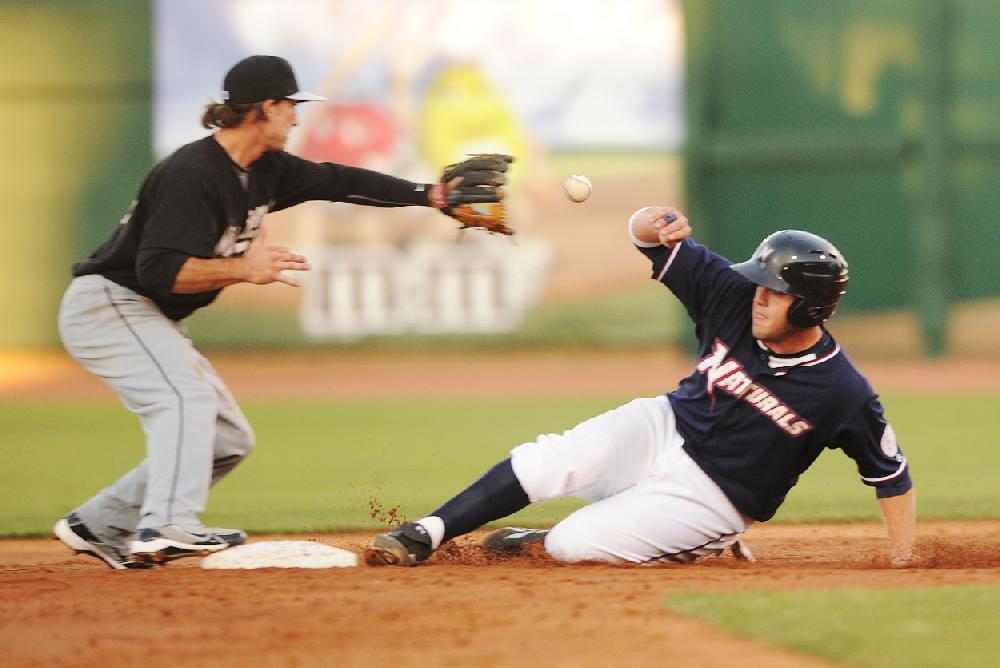 Arkansas Democrat-GazetteMICHAEL WOODS --07-01-10-- Naturals baserunner Mike Moustakas slides safely into second base as San Antonio short stop Drew Cumberland takes the throw in the 3rd inning of Thursday nights game at Arvest Ballpark in Springdale.