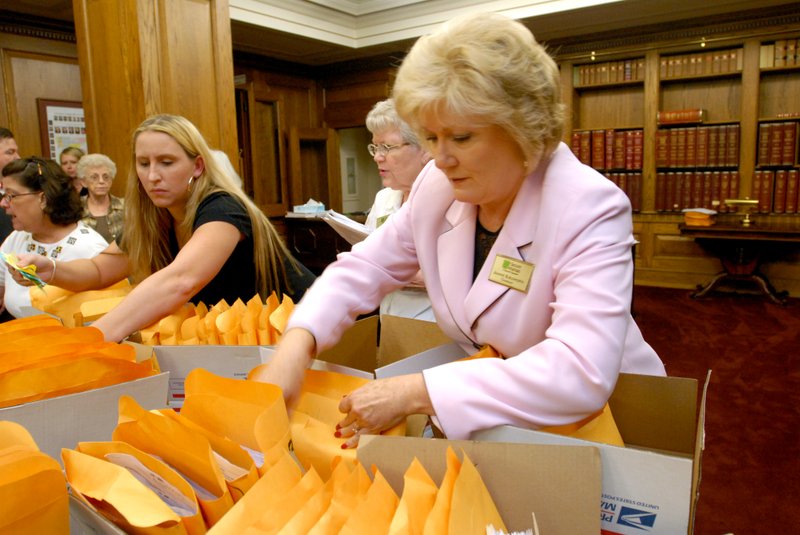 Jeannie Burlsworth (at right) and Brean Schoultz, both with Secure Arkansas, sort through boxes of signed petitions on Friday, July 2, 2010, at the Secretary of State's office.