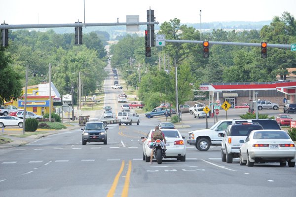 Traffic passes through the intersection of Garland Avenue and Wedington Drive on Friday in Fayetteville. The Arkansas Highway and Transportation Department is planning to hold another public meeting to gather input on the department’s plans to widen Garland Avenue north of the intersection.