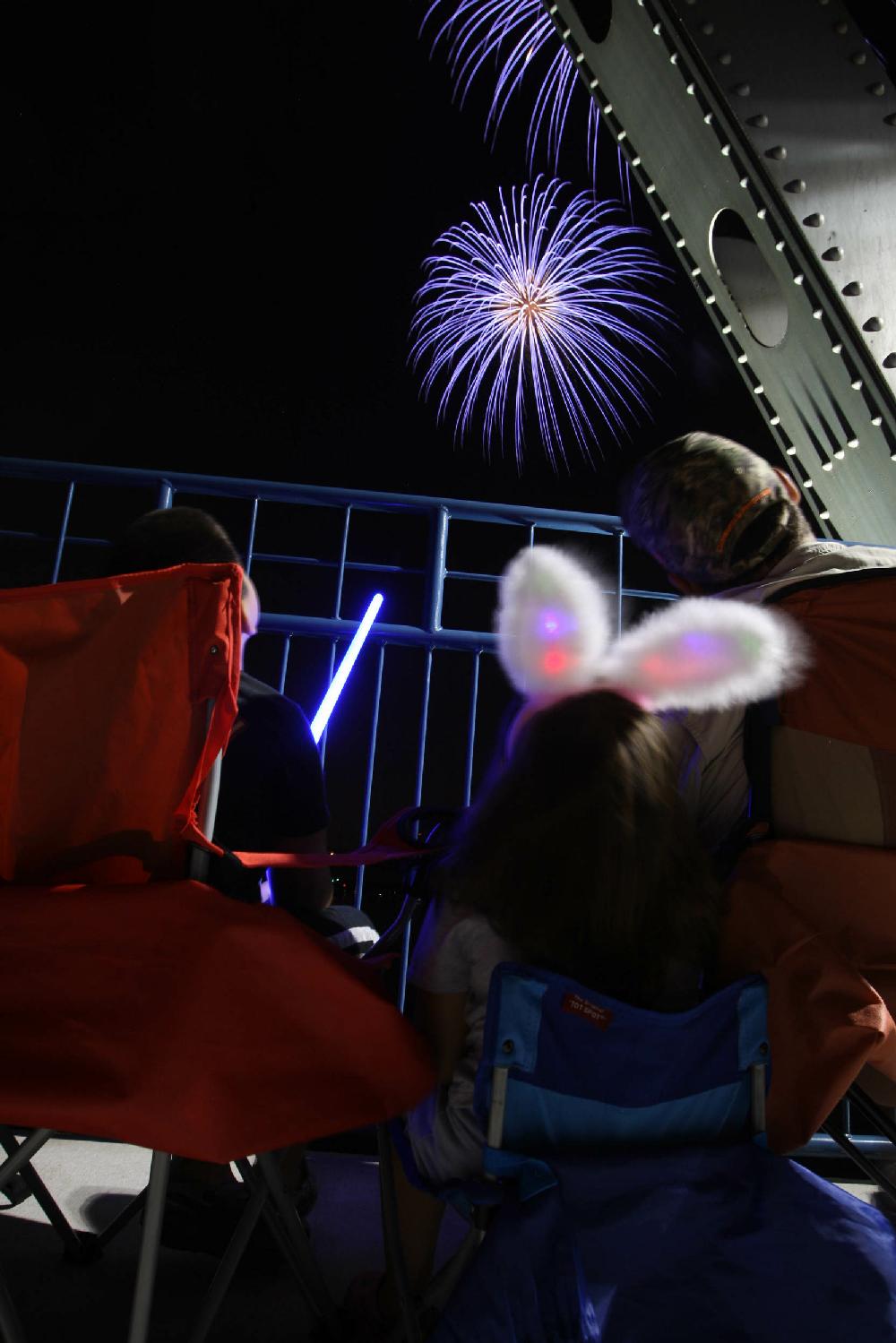 7410Arkansas Democrat-GazetteSTEPHEN B. THORNTONSpectators watch the Pops on the River fireworks display from the Junction Bridge over the Arkansas River Sunday night.