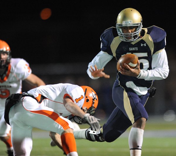 Shiloh Christian’s Kiehl Frazier, right, fends off Nashville’s Erin Adams in their Class 4A playoff game Nov. 27 in Champions Stadium in Springdale.