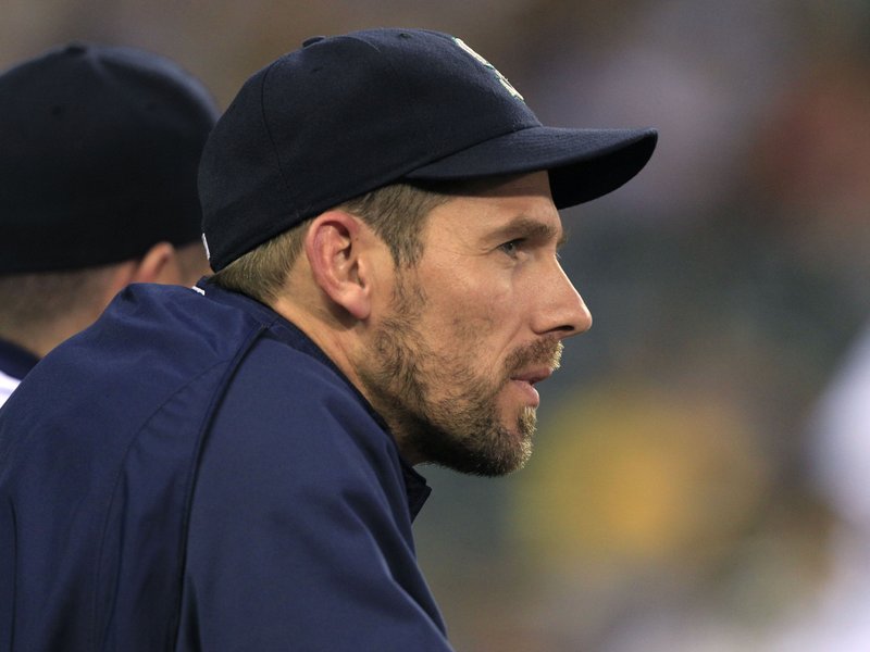  	Seattle Mariners pitcher Cliff Lee  watches the game against the Kansas City Royals from the dugout in the eighth inning during a baseball game on Tuesday, July 6, 2010, in Seattle. 