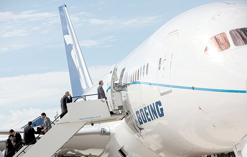 Visitors enter a Boeing 787 Dreamliner on Monday at the Farnborough International Airshow in Farnborough, United Kingdom.