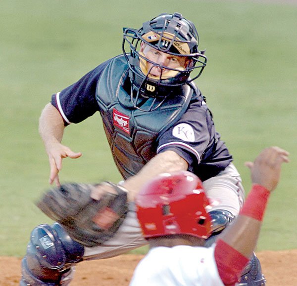 Northwest Arkansas catcher Jeff Howell reaches back to tag Arkansas’ Charlton Jimerson as he slides home in the bottom of the fourth inning of Monday’s game at Dickey-Stephens Park in North Little Rock.