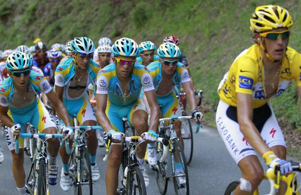 Andy Schleck of Luxembourg, wearing the overall leader's yellow jersey, is followed by Alberto Contador  of Spain, center, and his Astana teammates as they climbs towards Port de Bales pass during the 15th stage of the Tour de France, Monday.