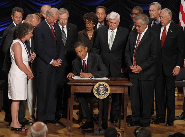 President Barack Obama signs the Dodd-Frank Wall Street Reform and Consumer Protection financial reform bill at the Ronald Reagan at the Ronald Reagan Building in Washington, Wednesday.