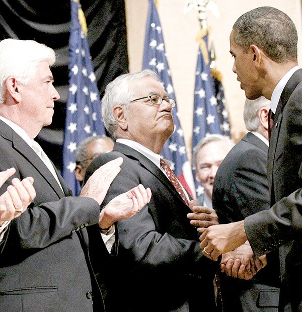 President Barack Obama greets Rep. Barney Frank (center), D-Mass., and Sen. Chris Dodd, D-Conn., before the signing ceremony Wednesday for the financial-overhaul bill the two lawmakers shepherded.