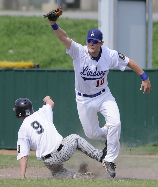 First baseman Gordon Miller records an out for Fayetteville Lindsey & Associates during Monday’s game against Mountain Home in the American Legion Zone 1 championship in Fayetteville.