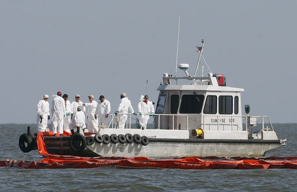 Workers prepare to lay oil boom around an island in St. Bernard Parish, La., Wednesday.