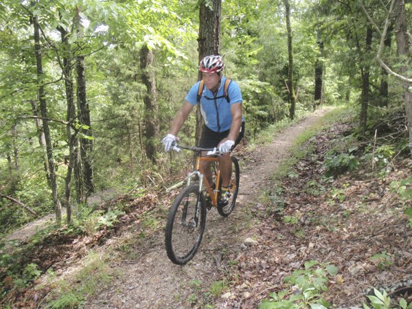 Tom Williams of Fayetteville pedals his way along the War Eagle Valley Loop at Hobbs State Park-Conservation Area. The 6-mile trail is a loop of the Hidden Diversity Multi-Use Trail. The entire trail is 21 miles.