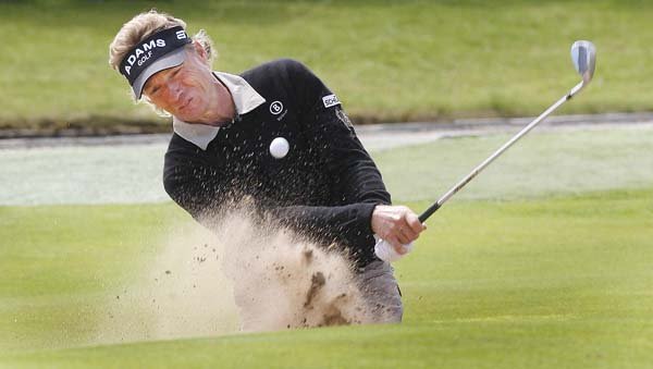 Germany’s Bernhard Langer plays from a bunker on the 18th hole during Thursday’s opening round of the British Seniors Open at Carnoustie Golf Club in Carnoustie, Scotland. Langer was in a threeway tie with England’s Carl Mason and American Jay Don Blake at 4-under-par 67.