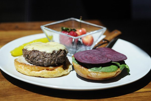 The wagyu burger at Hjem Restaurant, made from extrahigh-grade beef, is served with beet slices, housemade juniper mayonnaise and paired with fresh fruit. Hjem, on the Fayetteville square, combines the tastes of the Pacific Northwest with those of Scandinavia.
