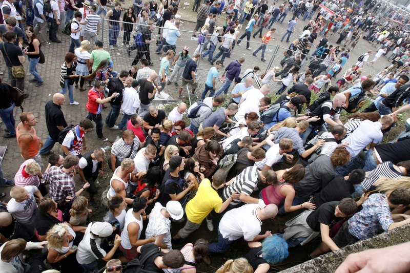 People try to leave the area after a panic on this year's techno-music festival "Loveparade 2010" in Duisburg, Germany, on Saturday, July 24, 2010. More than a dozen people were killed and others injured when mass panic broke out in a tunnel at the Love Parade. 