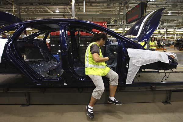 Kelly Martinelli works Thursday on a preproduction 2012 Ford Focus at an assembly plant in Wayne, Mich.