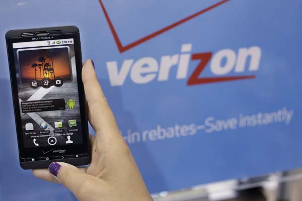 A Best Buy customer in Mountain View, Calif., looks Wednesday at a Motorola Droid phone by Verizon.