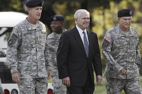 Gen. Stanley McChrystal (from left) walks Friday with Defense Secretary Robert Gates and Army Chief of Staff Gen. George Casey Jr. as McChrystal is honored at a retirement ceremony at Fort McNair in Washington.
