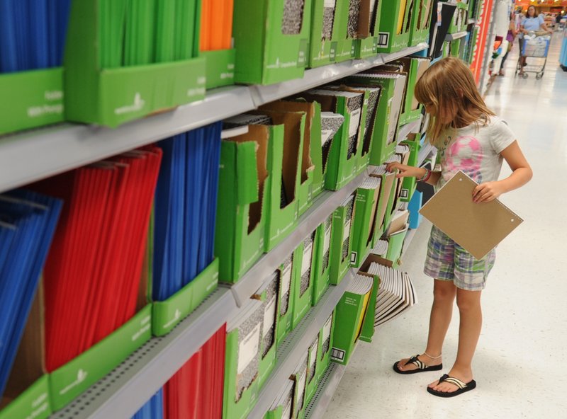 Ryan Jungmeyer, 8, of Fayetteville looks for her school supplies while shopping with her mother Wednesday afternoon at the Wal-Mart supercenter on Mall Avenue in Fayetteville.
