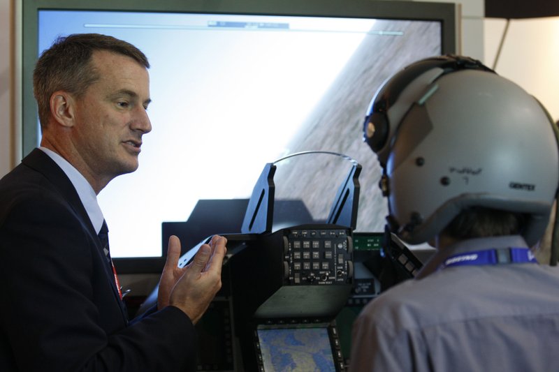 Todd Lovell, Raytheon Inc.’s avionics department manager, explains the company’s pilot-helmet display technology at the Farnborough International Airshow last week near London.