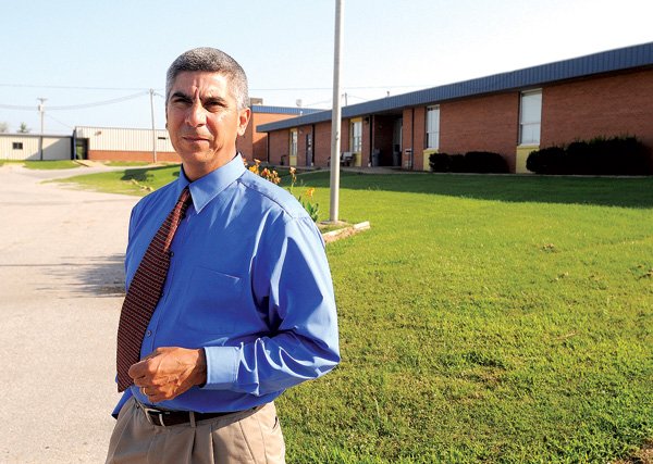 Dr. Larry Ben, new superintendent of Decatur schools, walks the grounds of the high school on July 19 in Decatur. The Decatur School District has been run by the state for the past two years because of fiscal distress. Ben comes to the new post from the Rogers School District where he served as an administrator and coach.