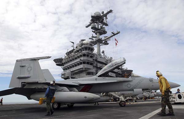 Joint U.S.-South Korea military drills A deck crew works next to an FA-18 Super Hornet on the USS George Washington during joint military drills in South Korea’s East Sea on Sunday.