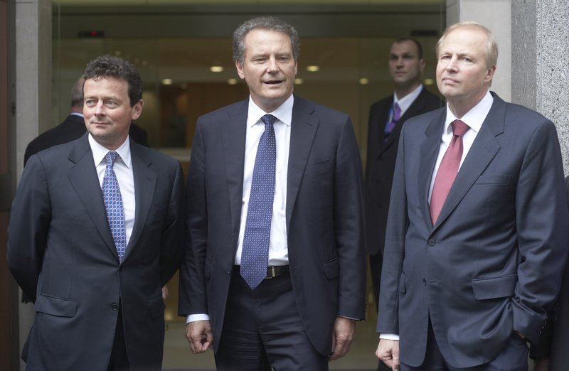 Tony Hayward, left, Carl-Henric Svanberg, chairman of BP, and Robert Dudley, incoming chief executive officer of BP Plc, arrive to speak to journalists at the company's headquarters in London on Tuesday, July 27, 2010. 