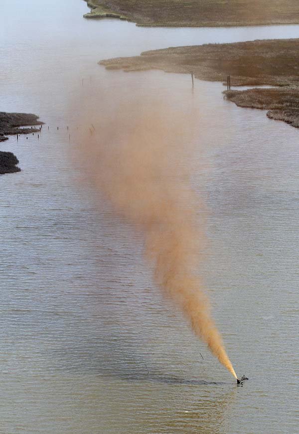 Oil spews from a wellhead after it was struck by a barge Tuesday near Barataria Bay on the coast of Louisiana.