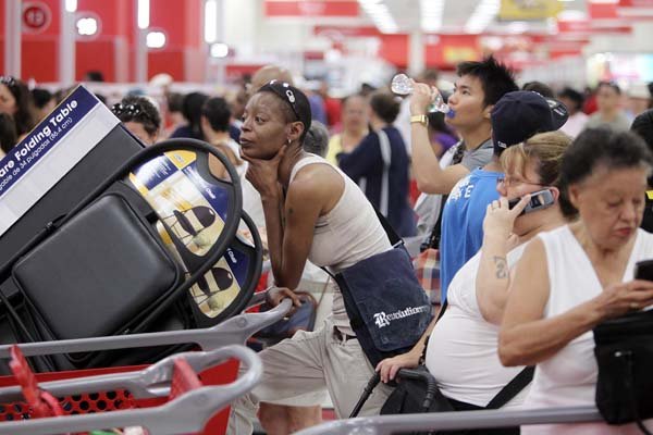 Customers wait to check out Sunday at the grand opening of a Target store in the Harlem neighborhood of New York City.