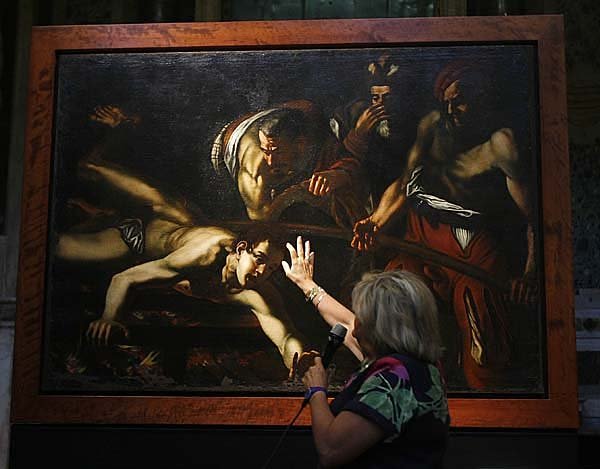 Art superintendent Rossella Vodret indicates Tuesday on the Martyrdom of St. Lawrence painting why she believes it was not painted by Caravaggio.
