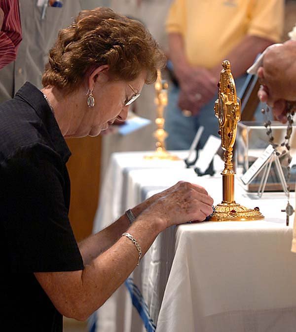 Donna McCall, from Hattieville, AR prays before a relic of Mother Teresa containing a small vial of her blood at the Cathedral of St. Andrew in Little Rock on Wednesday evening. Five relics from Mother Teresa:  a lock of her hair, a small vial of blood, a pair of sandals, a crucifix and a rosary, were on display.  