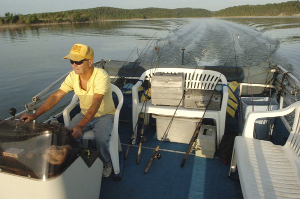 A pontoon boat gets Fred Beaman of Prairie Creek to his favorite fishing spots at Beaver Lake.