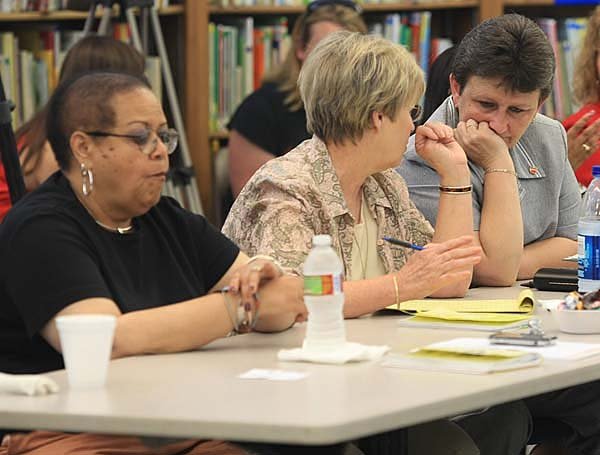 Negotiator Deen Minton (left) and Pulaski Association of Classroom Teachers President Marty Nix wait Wednesday for a courtordered mediation session to begin in Little Rock.