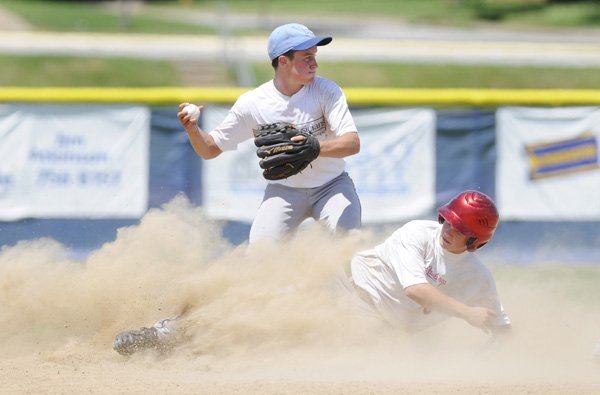  Northwest Arkansas’ Brandon Jansen looks to make a double play Thursday after tagging out Rawlings Wheeler’s Jackson Burns during the Premier Baseball National Sophomore Championship at 
Tyson Sports Complex in Springdale.
